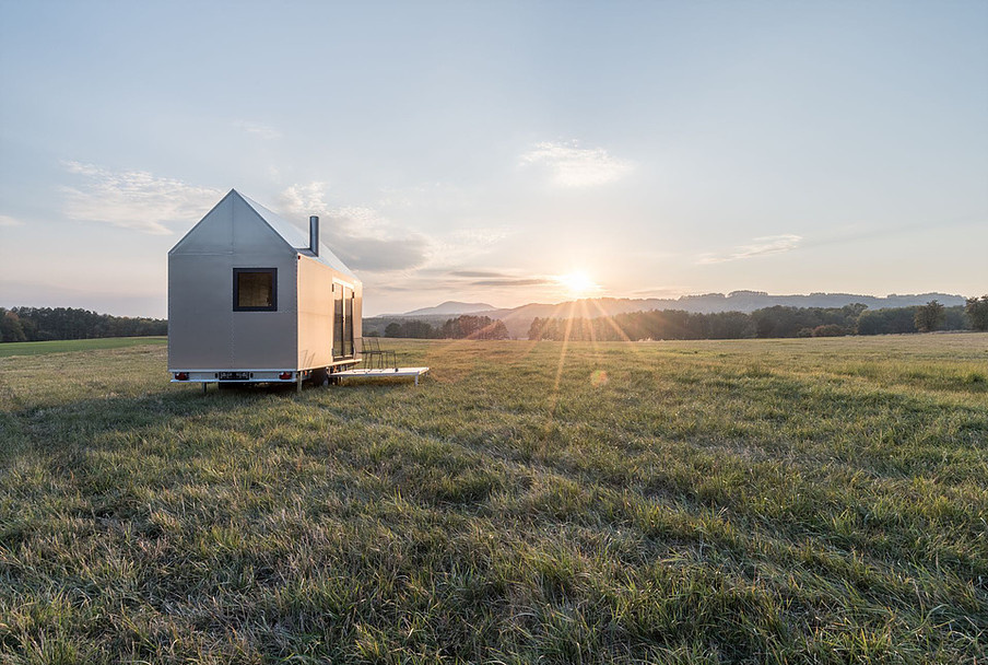 Mobile Hut je moderní domek v hliníkovém designu, přesto svým tvarem inspirovaný klasickým českým domem se sedlovou střechou a komínem.