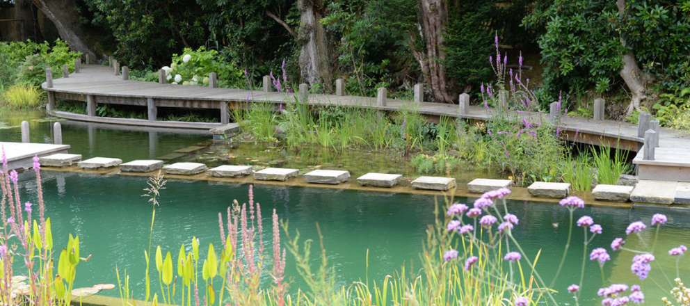 Koupací jezírko vypadá v zahradě mnohem přirozeněji, než zářivě modrý bazén. Foto: Naturalswimmingpools.com