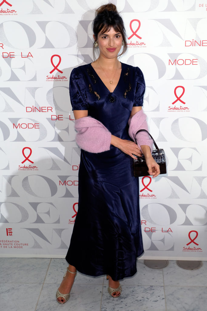 Na fashion weeku v Paříži v lednu 2019 v tmavě modrých šatech v kombinaci s růžovým svetříkem
